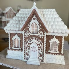 a close up of a gingerbread house on a table