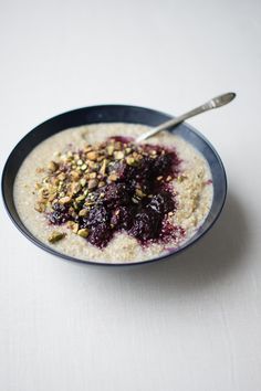 a bowl of oatmeal with berries and nuts