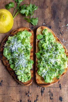 two pieces of bread with guacamole and parmesan cheese on them