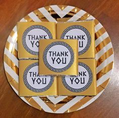 four thank you chocolates on a plate with the words thank you written on them