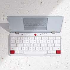 a computer keyboard sitting on top of a white desk