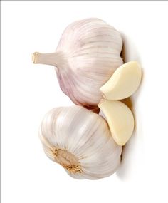 two bulbs of garlic on a white background