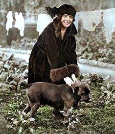 an old photo of a woman and her dog