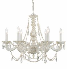 a white chandelier with crystal drops hanging from it's center and four arms