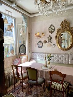 a dining room filled with furniture and a chandelier