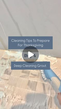 a person using a brush to clean tile