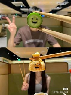 a woman holding chopsticks in front of her face with food hanging from them