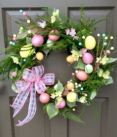 an easter wreath is hanging on the front door