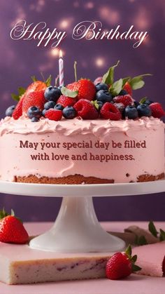 a birthday cake with strawberries and blueberries on top is sitting in front of a purple background