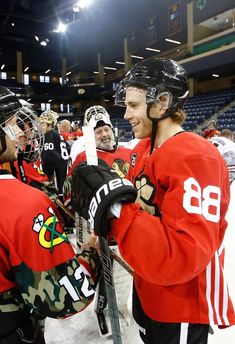 the hockey players are talking to each other