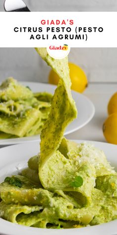 guacamole being lifted from a white plate with lemons in the background