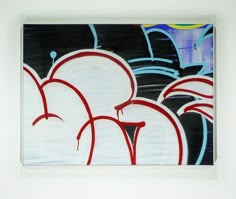 a piece of art with red and blue graffiti on it's sides, in front of a white wall