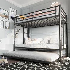 a bunk bed in a room with a black rug and pictures on the wall behind it