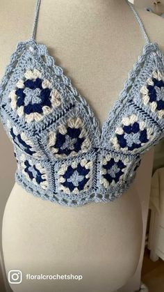 a crocheted bralet is displayed on a mannequin's torso