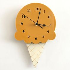 an ice cream cone clock on a white wall