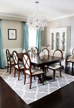 a dining room table with chairs and a chandelier