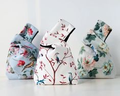 three small vases sitting on top of a white counter