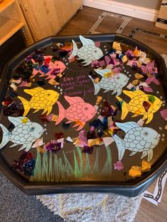 a tray that has some fish on it with candy in the bottom and writing on top