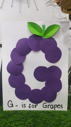 a paper cut out of the letter g is for grapes