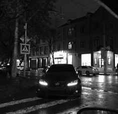 a car is driving down the street at night