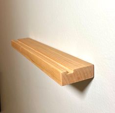 a wooden shelf hanging on the wall