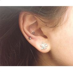 a woman with ear piercings on her left side and the top part of her ear