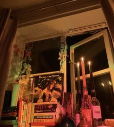 a window sill filled with books and candles