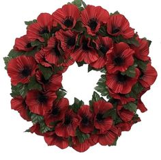 a wreath with red flowers and green leaves