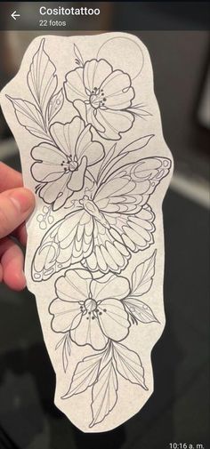 someone holding up a sticker with flowers on it