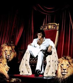 elvis presley sitting on a throne surrounded by lions in front of a red velvet curtain