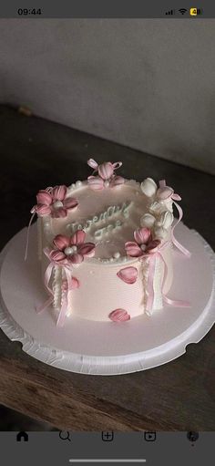 a white cake with pink flowers on it