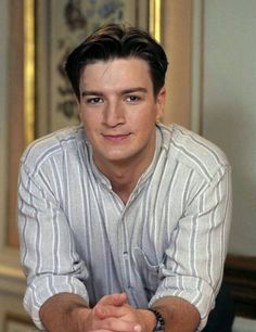 a young man sitting on top of a chair