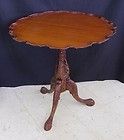 a small wooden table with one leg on it