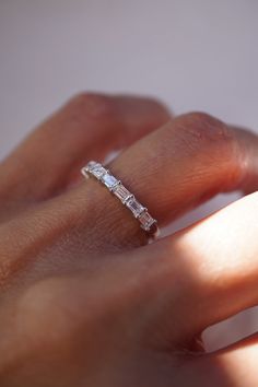 a woman's hand with a diamond ring on it