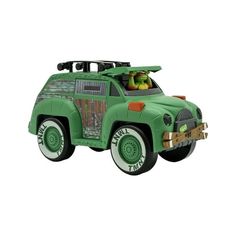 a green toy truck with an animal in the back and two people sitting on top