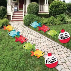 lawn decorations with fish on them in front of a house