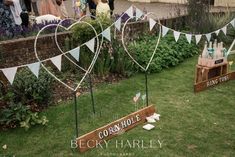 wedding decorations made out of wooden crates and bunting on the grass in front of a brick wall