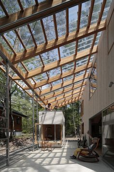 the inside of a house that is being built with wooden slats and glass roof