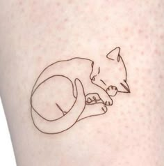 a small tattoo on the leg of a woman with a cat and bird in it