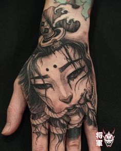 a woman's hand with tattoos on it