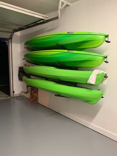 several green surfboards are hanging on the wall