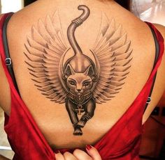 the back of a woman's neck with an owl and cat tattoo on it