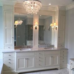 a large bathroom with double sinks and two mirrors