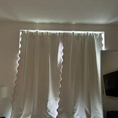 the curtains are hanging in front of the window