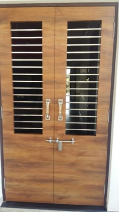 a large wooden door with metal bars on the sides and side panels that have been made to look like wood