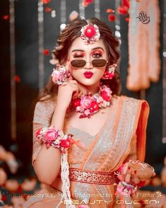 a woman in an orange and white outfit with flowers on her head, wearing sunglasses