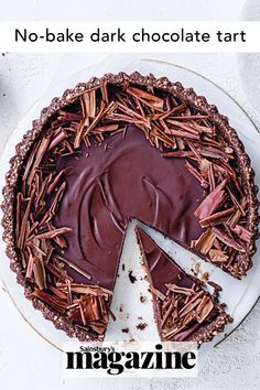 no - bake dark chocolate tart on a white plate with a slice missing