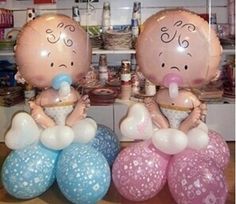 two balloons that look like babies sitting on top of each other