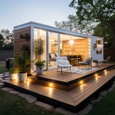 a small house with lights on the deck