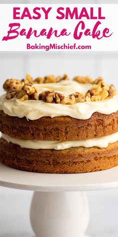 a cake with white frosting and walnuts on top is sitting on a plate